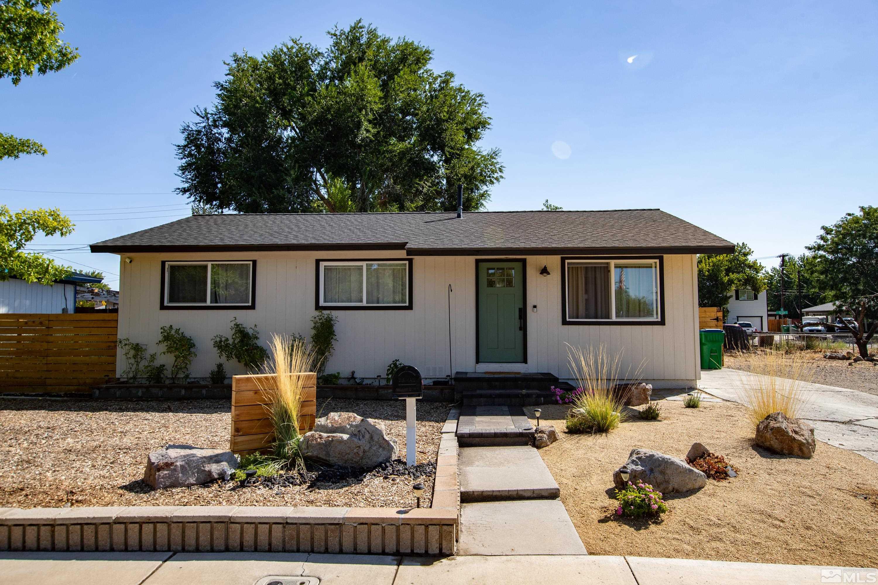 a front view of a house with yard outdoor seating and green space