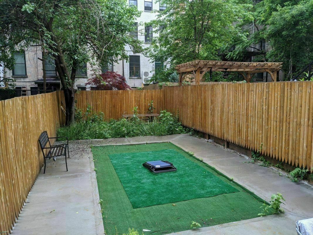 a view of a backyard with sitting area