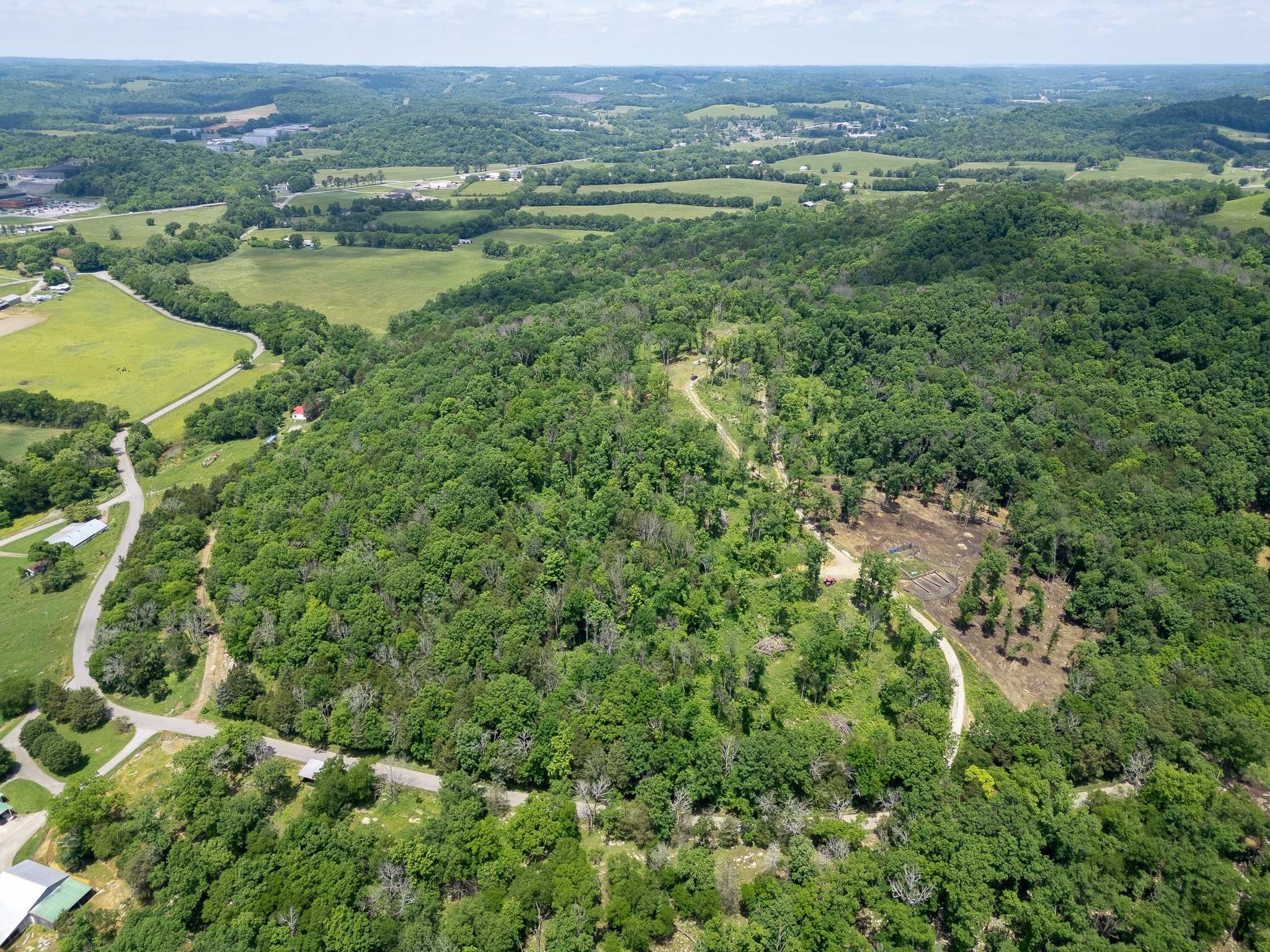 an aerial view of residential houses with outdoor space and trees