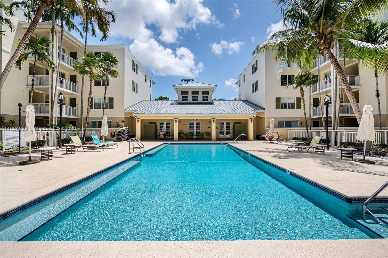 a view of a house with swimming pool and sitting area