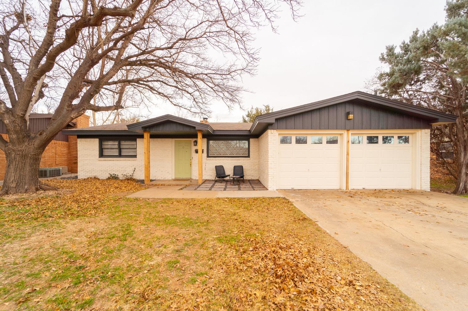 a view of a house with a yard and garage