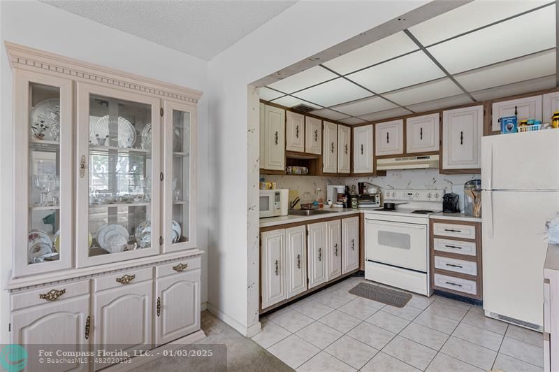 a kitchen with granite countertop appliances cabinets and a sink