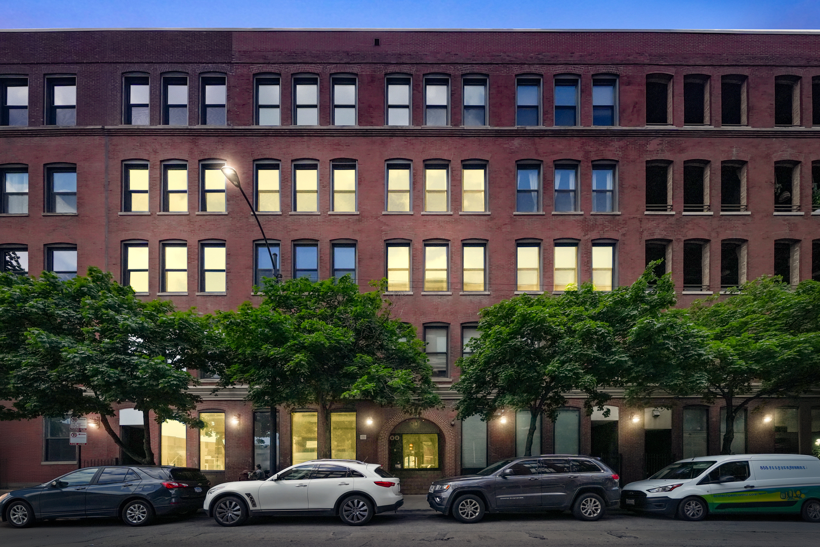 a couple of cars parked in front of a building