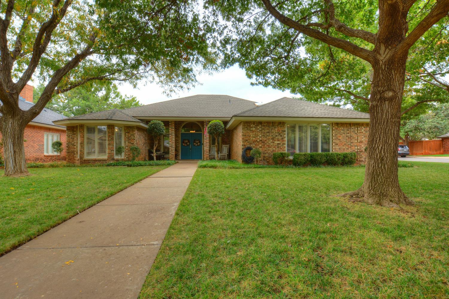 a front view of house with yard and green space