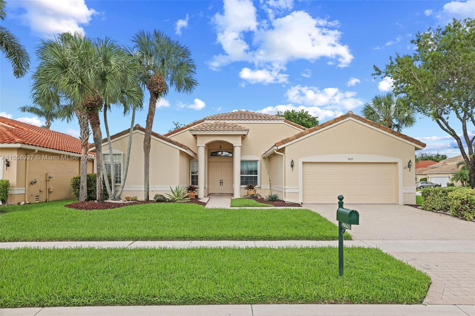 a front view of a house with a yard and garage