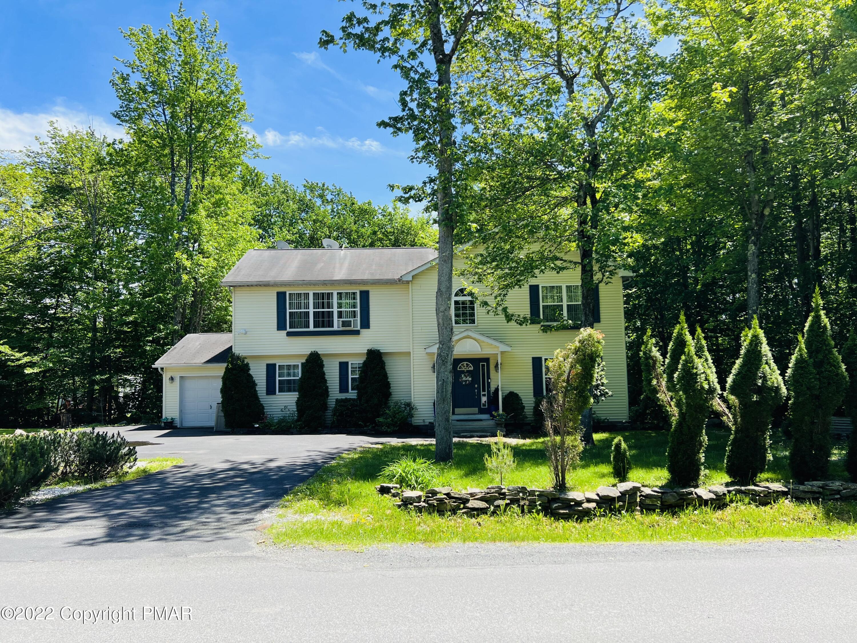 a front view of house with yard and green space