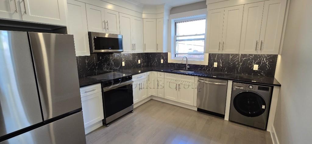 a kitchen with a refrigerator sink and cabinets