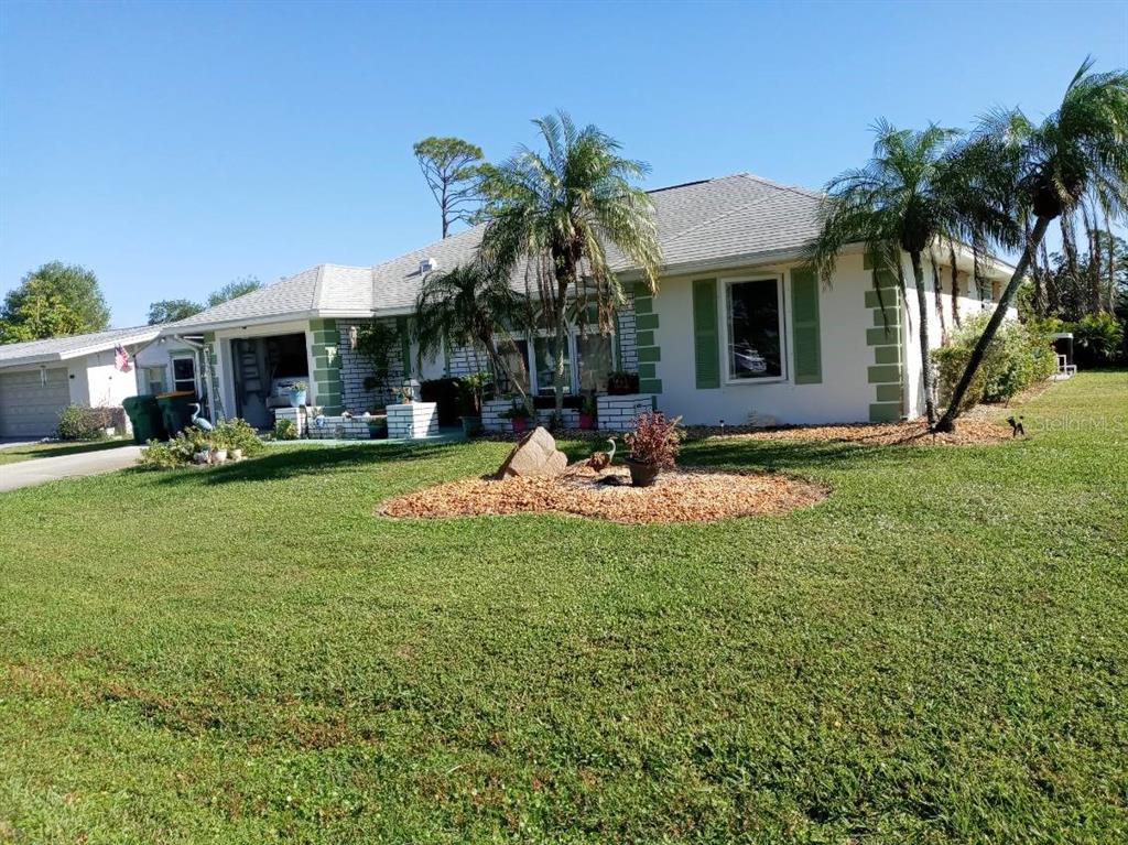 a view of a house with a backyard porch and sitting area