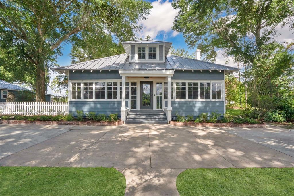 a front view of a house with yard patio and green space