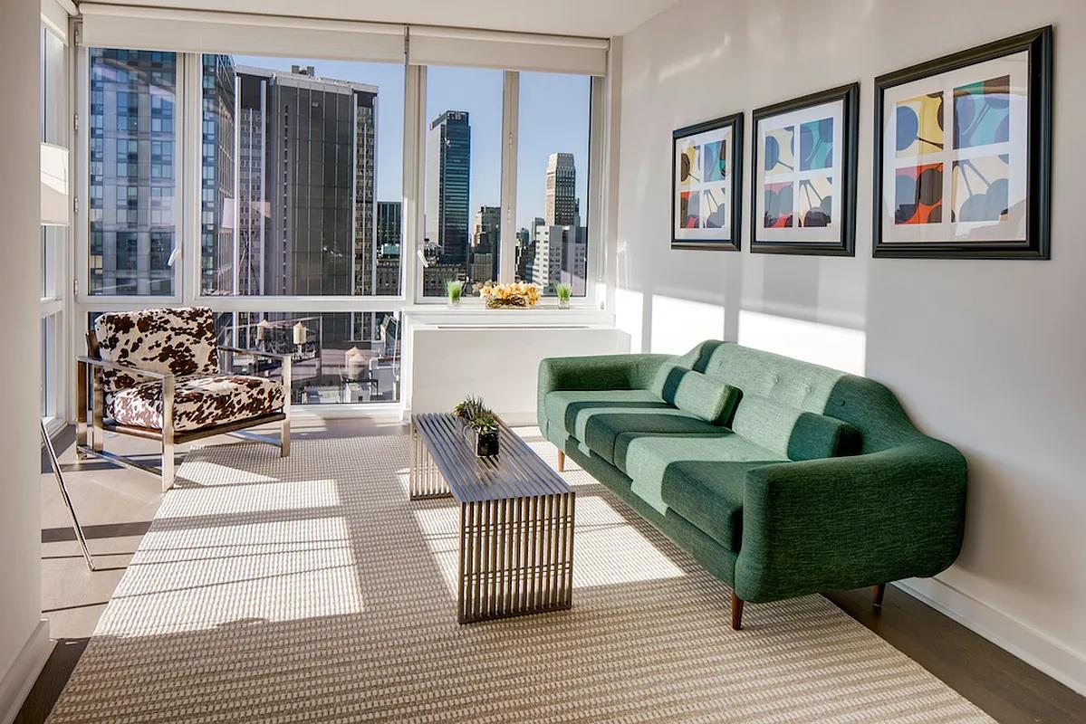 a living room with furniture and painting on the wall