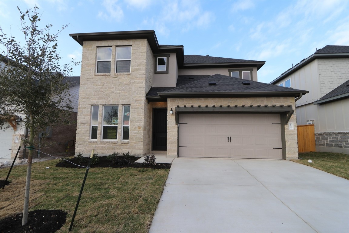 a front view of a house with garage