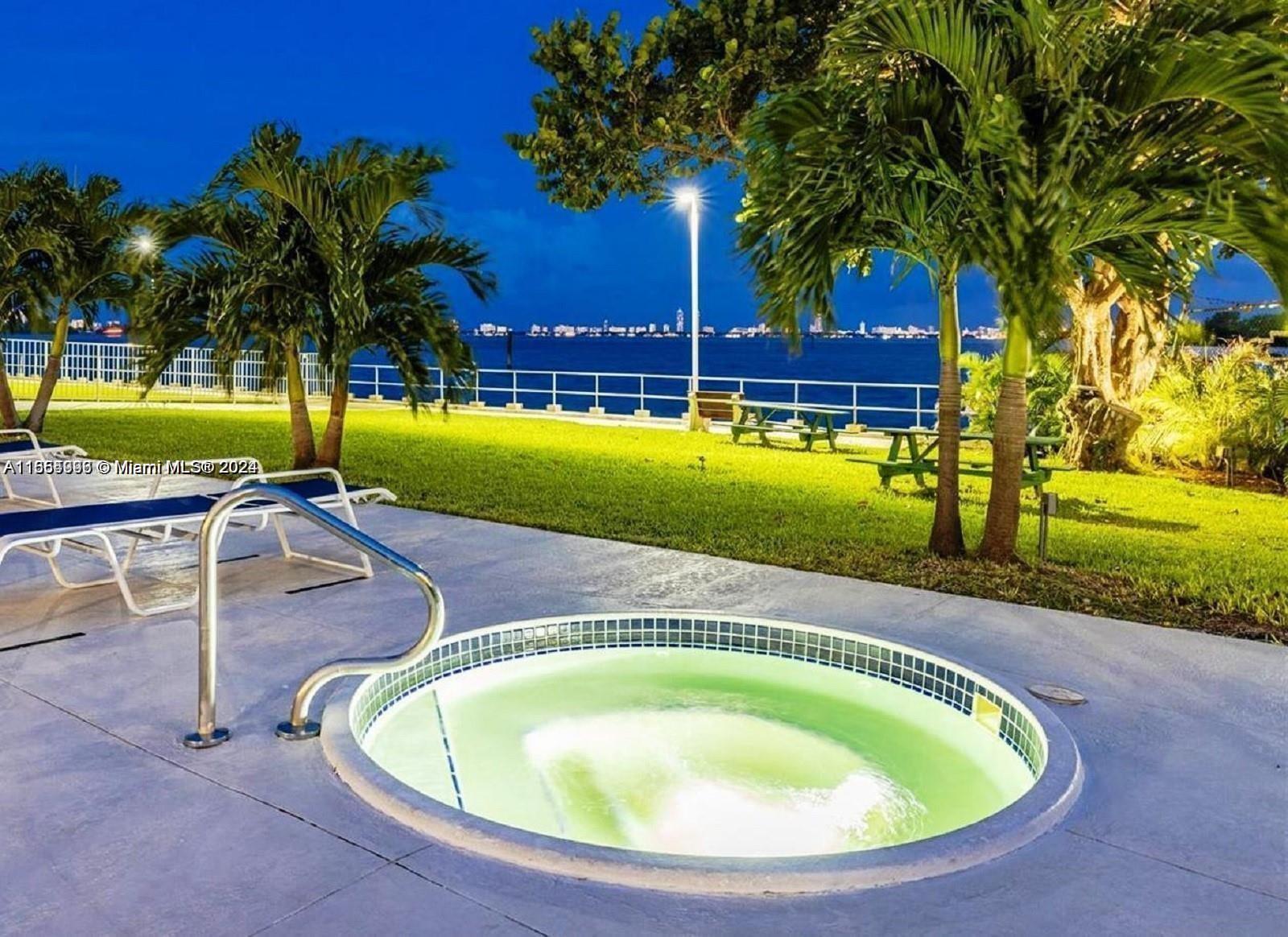 a view of a swimming pool with a yard