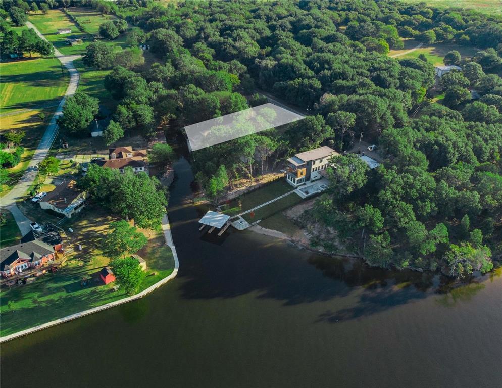 an aerial view of a house with a garden and lake view