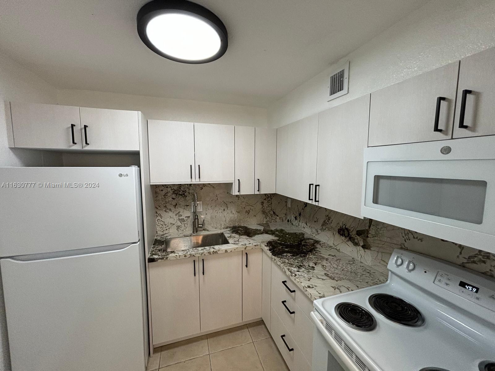 a kitchen with a stove and a refrigerator