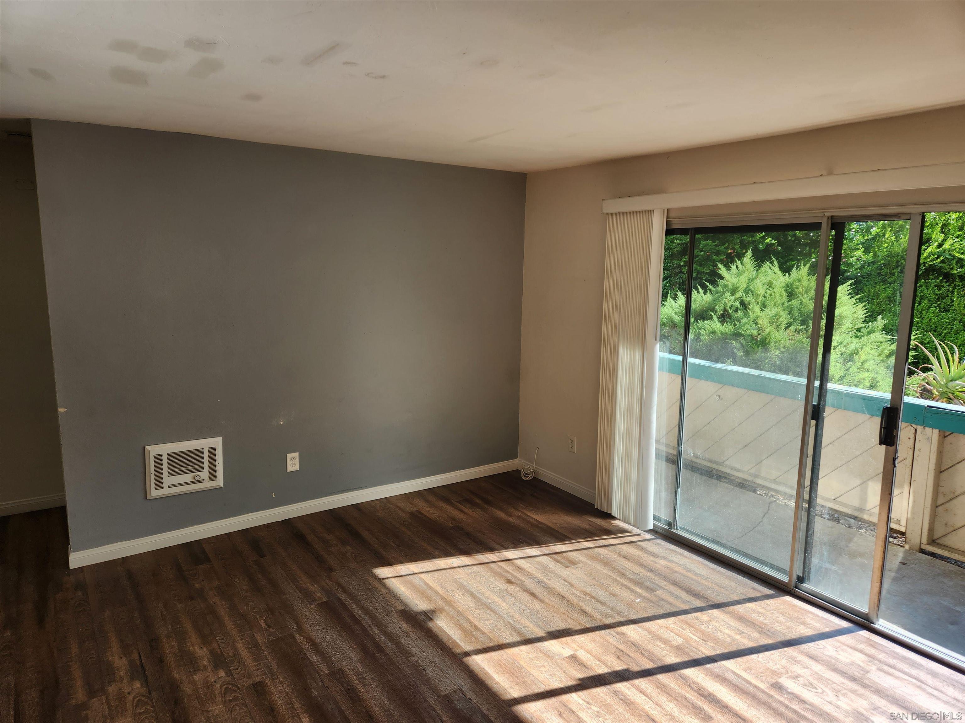 a view of a room with wooden floor and balcony