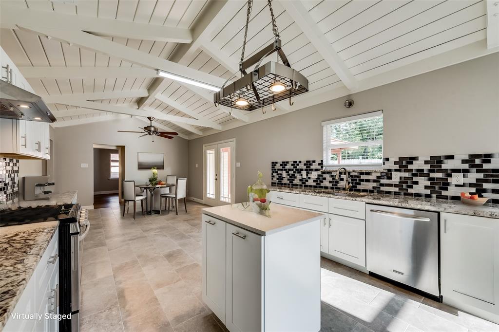 a kitchen with lots of counter top space and dining table