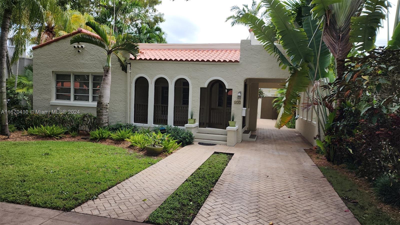 a front view of a house with garden