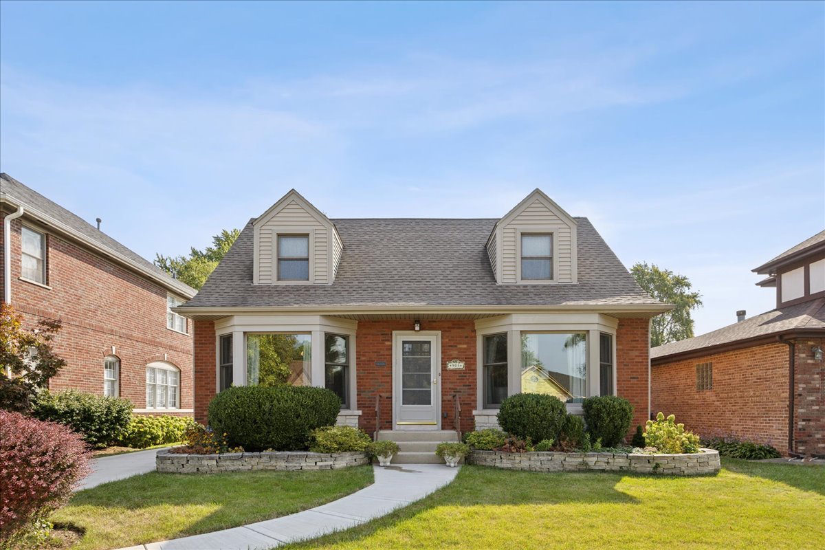 a front view of a house with swimming pool and outdoor seating