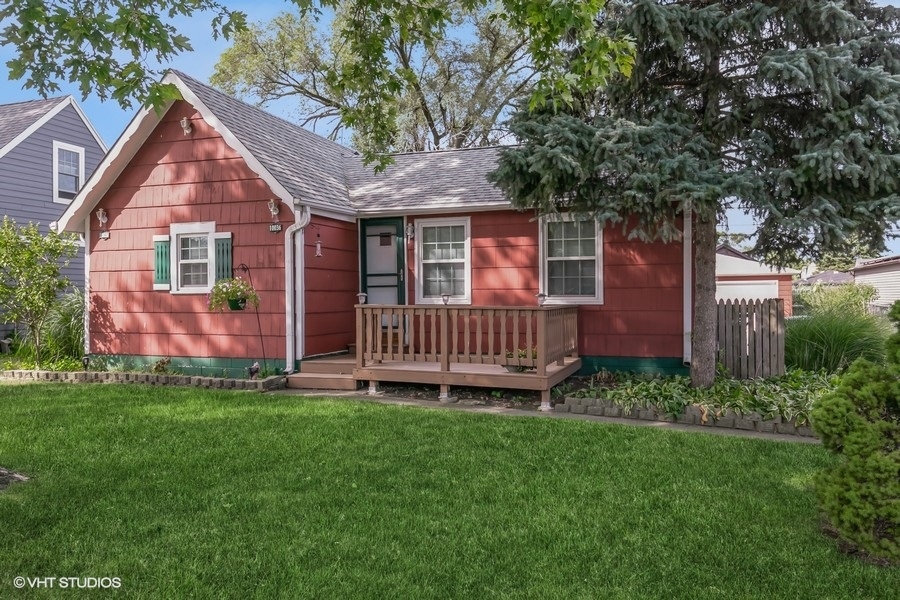 a view of a house with a backyard and deck