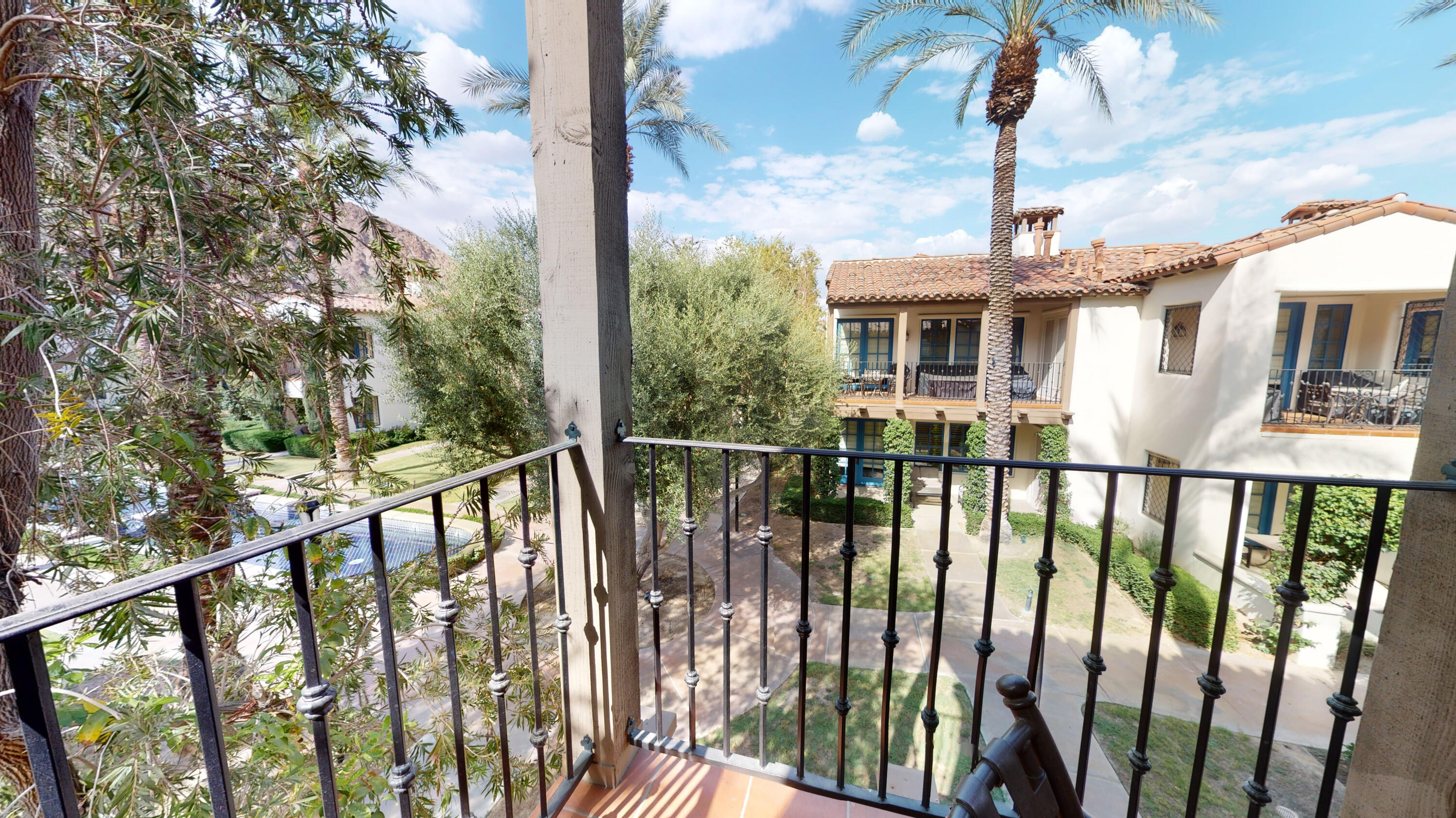 a view of a houses with a trees from a balcony