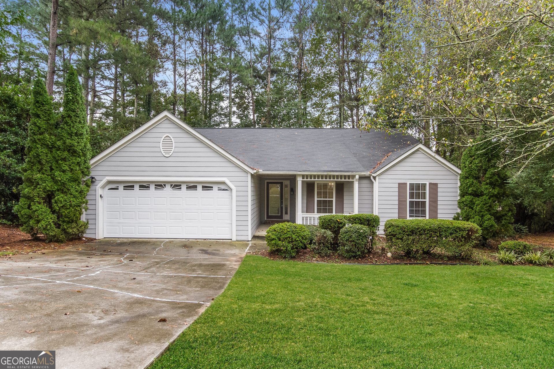 a view of a house with a yard and garage