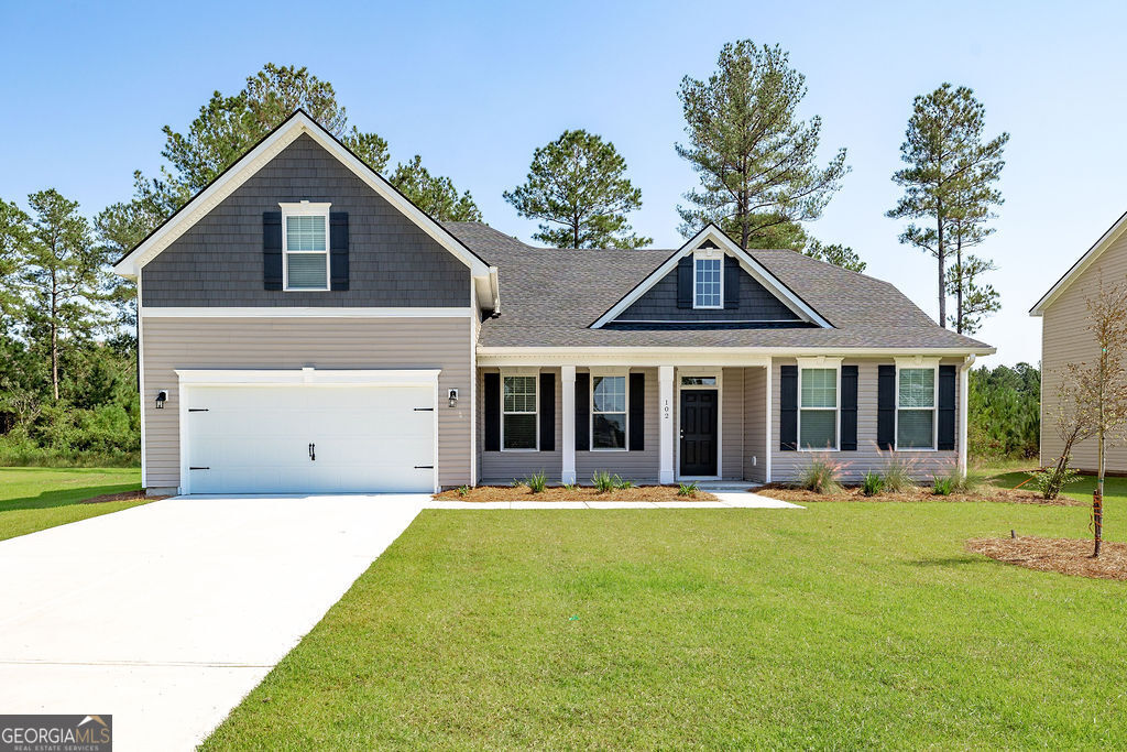 a front view of house with yard outdoor seating and barbeque