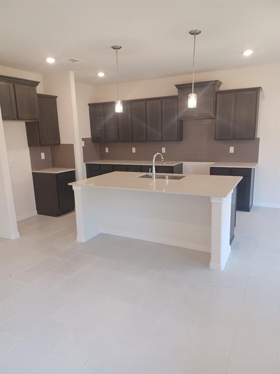 a large kitchen with a large counter top appliances and cabinets