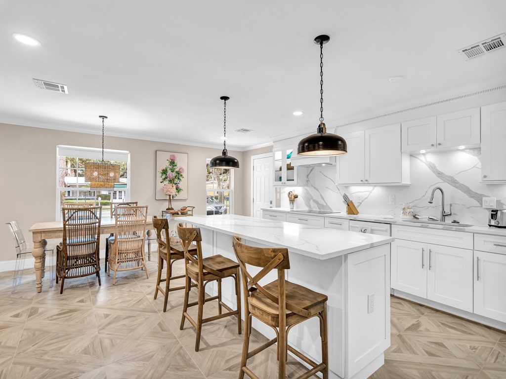 a kitchen with center island table and chairs