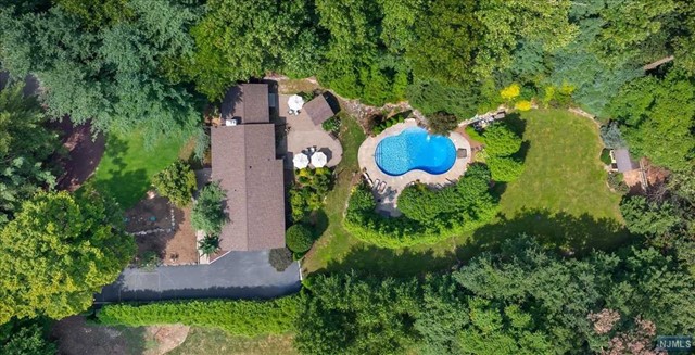 an aerial view of a house with a yard and outdoor seating