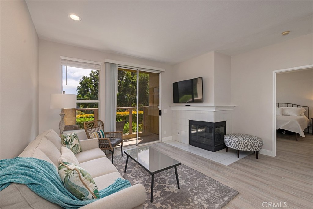 a living room with furniture flat screen tv and a fireplace