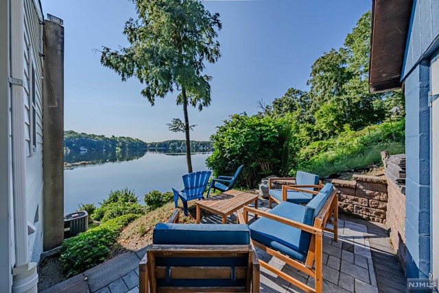 a view of a patio with furniture and a garden