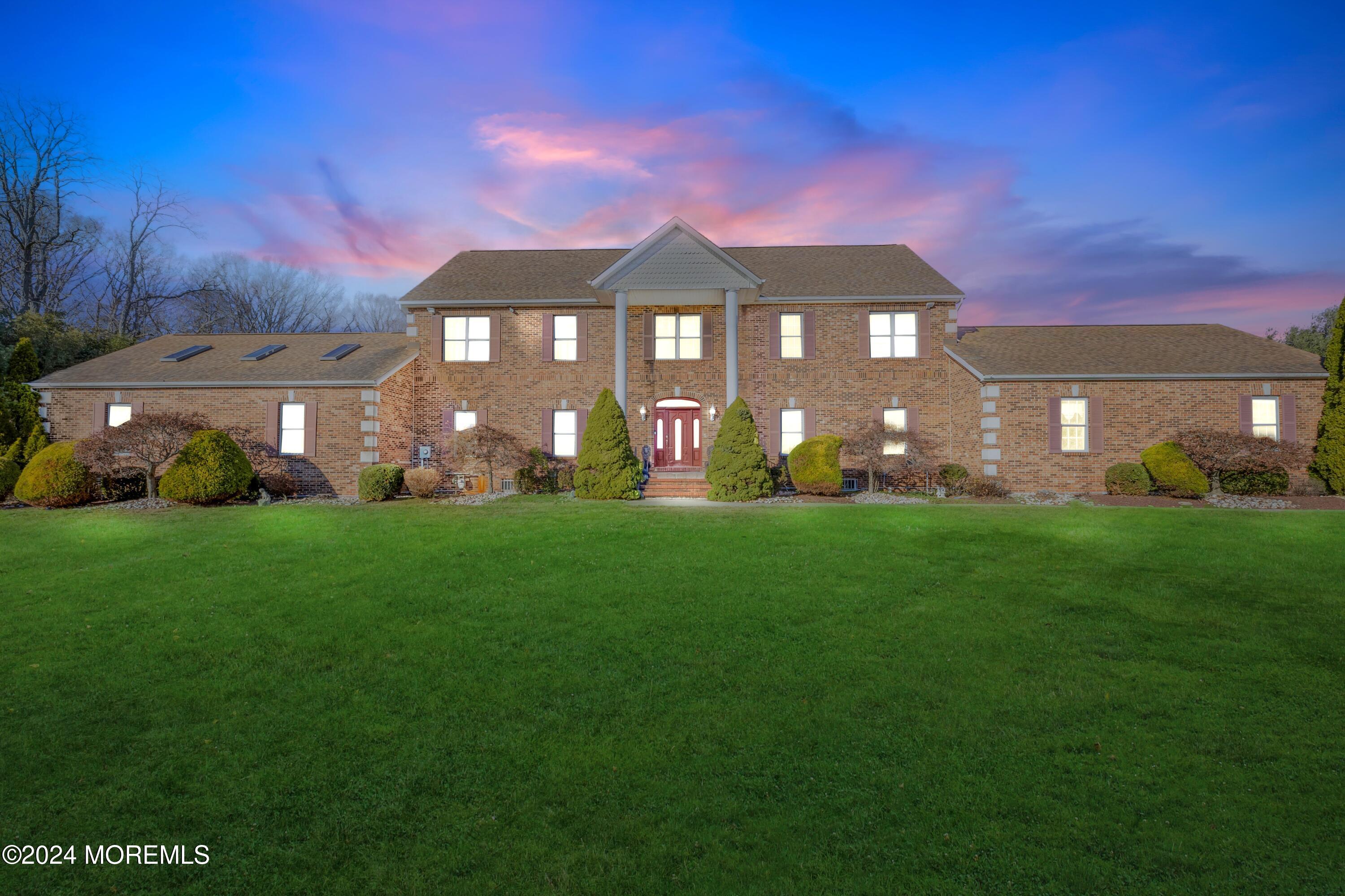 a front view of a house with garden and outdoor seating