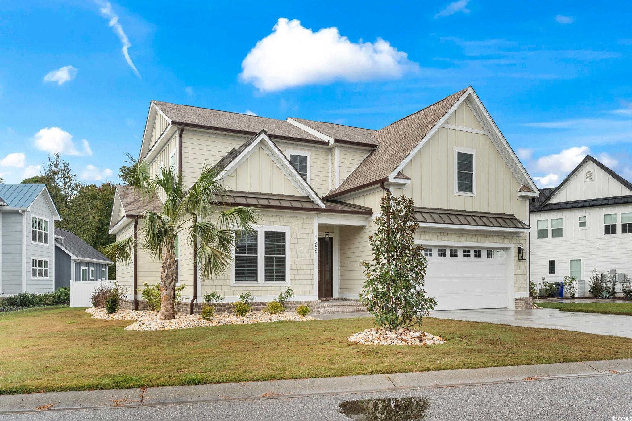 View of front of property featuring a garage and a