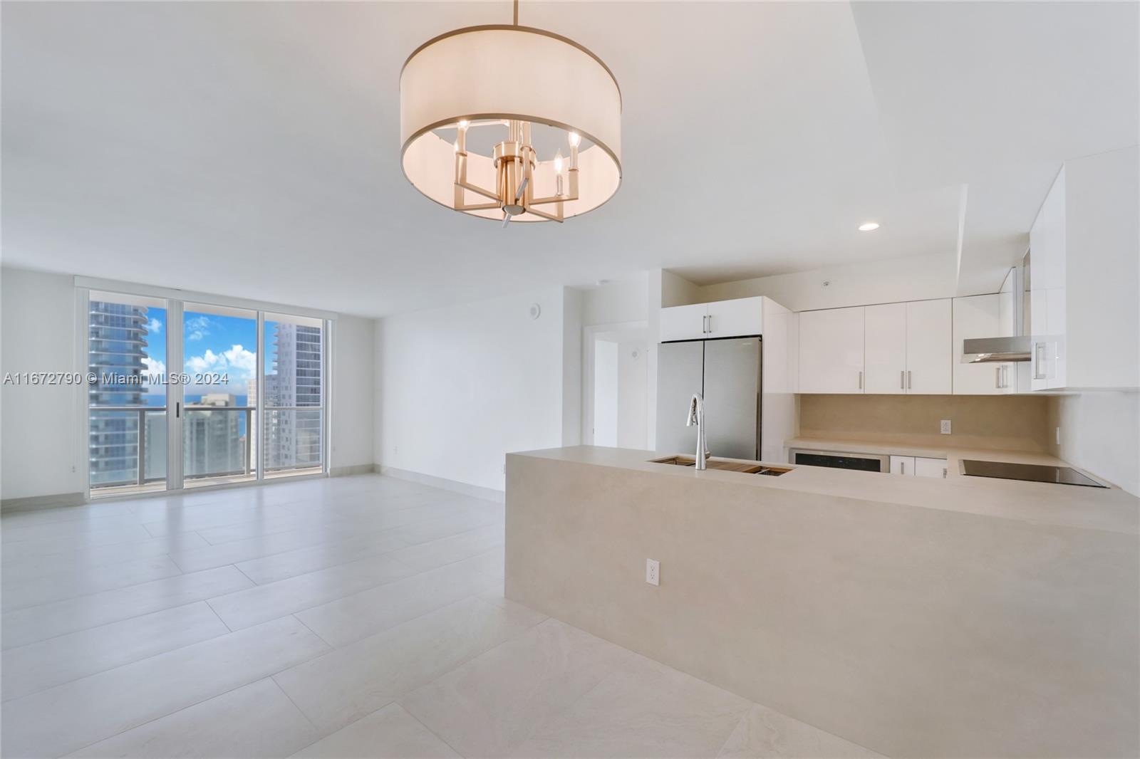 a view of a kitchen with marble kitchen and stainless steel appliances