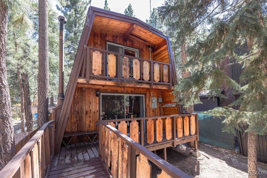 a view of a brick house with wooden fence and floor