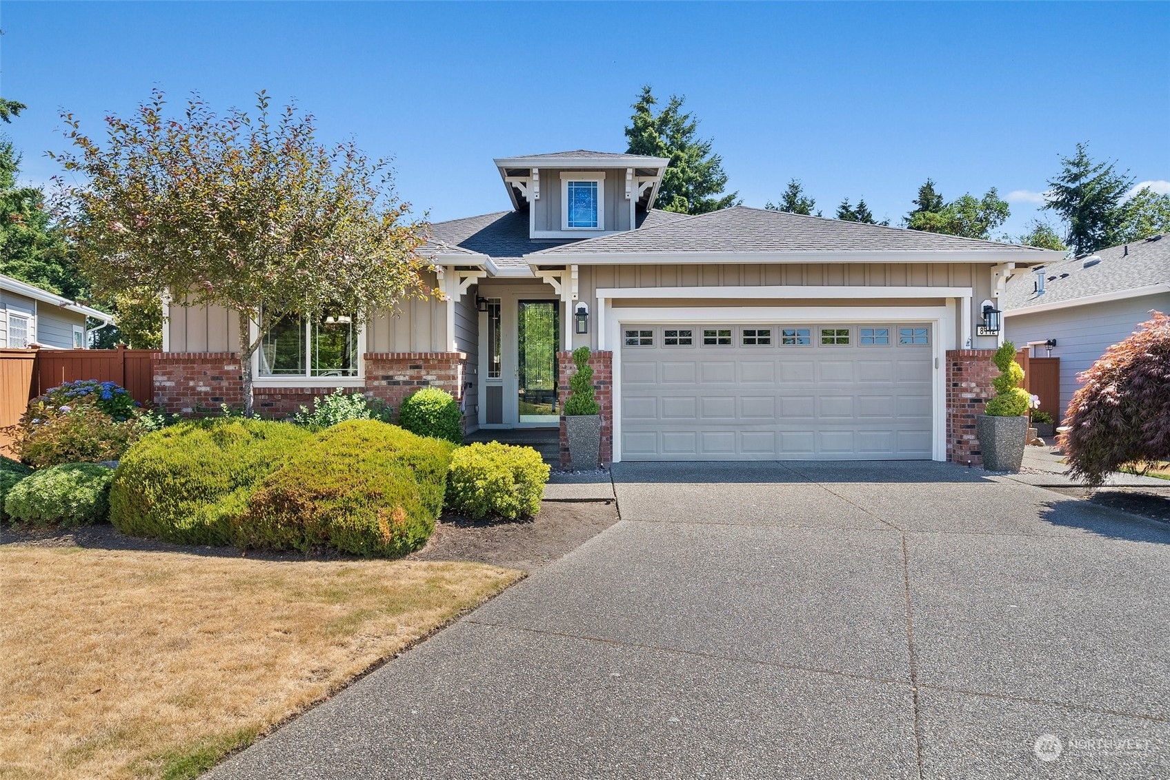 a front view of a house with a yard and garage