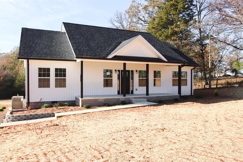 a front view of a house with a yard covered in snow