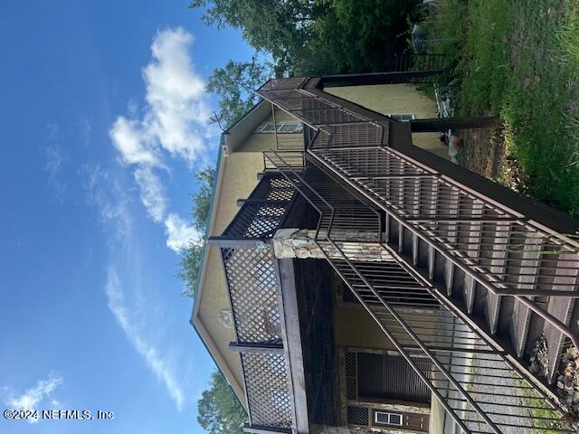 a view of a house with wooden fence