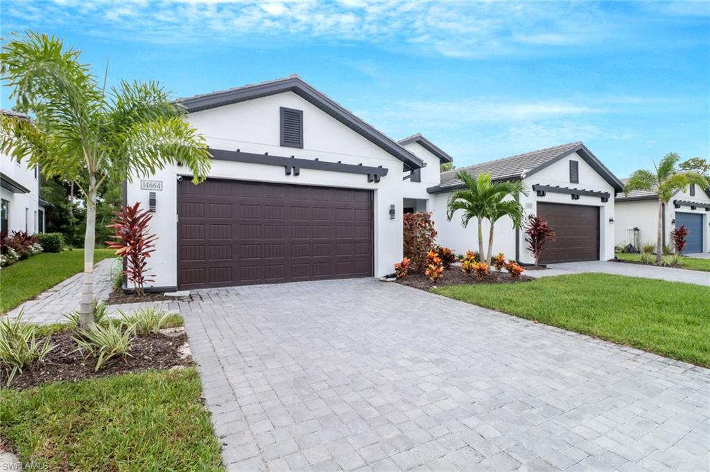 a front view of a house with a yard and garage