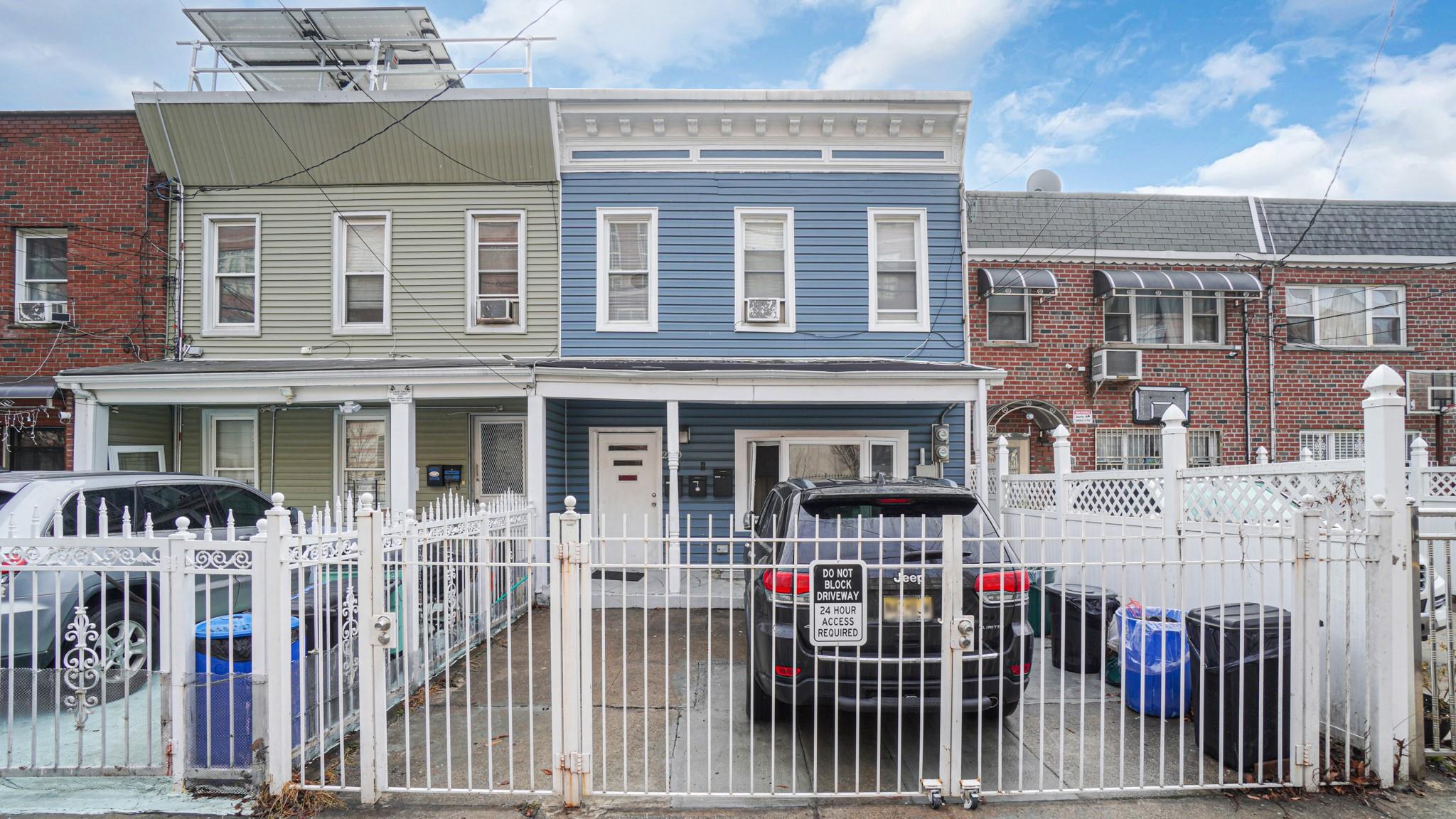 a front view of a house with iron fence