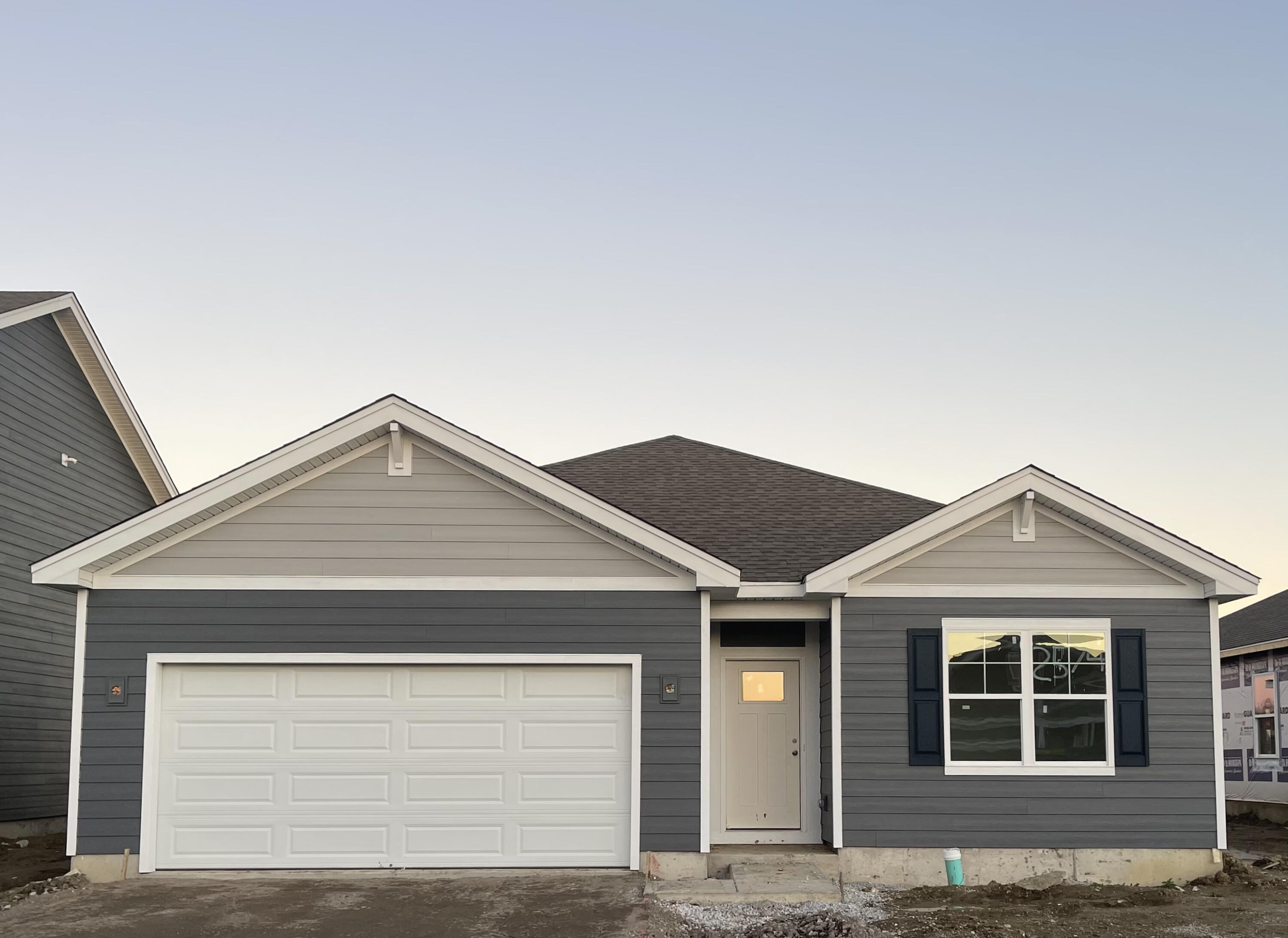 a front view of a house with a garage