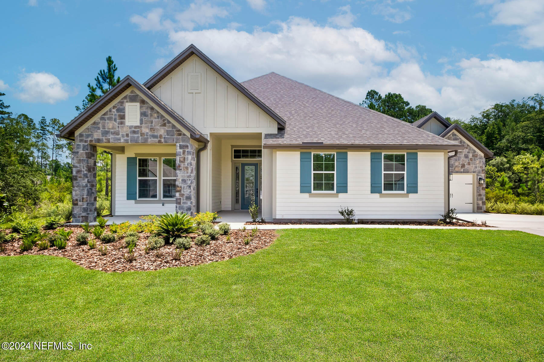 a front view of a house with a garden