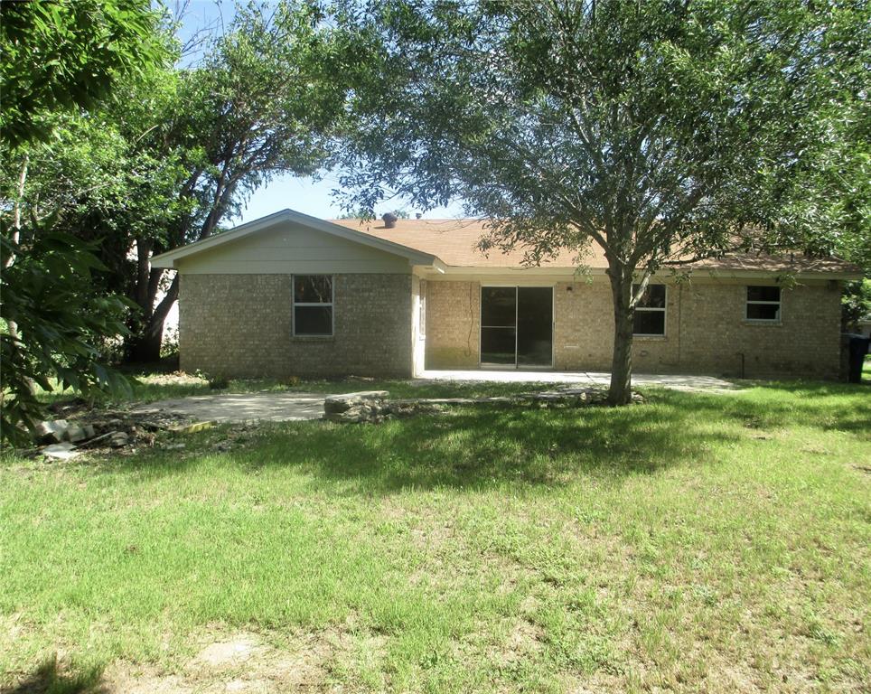 a front view of house with yard and trees