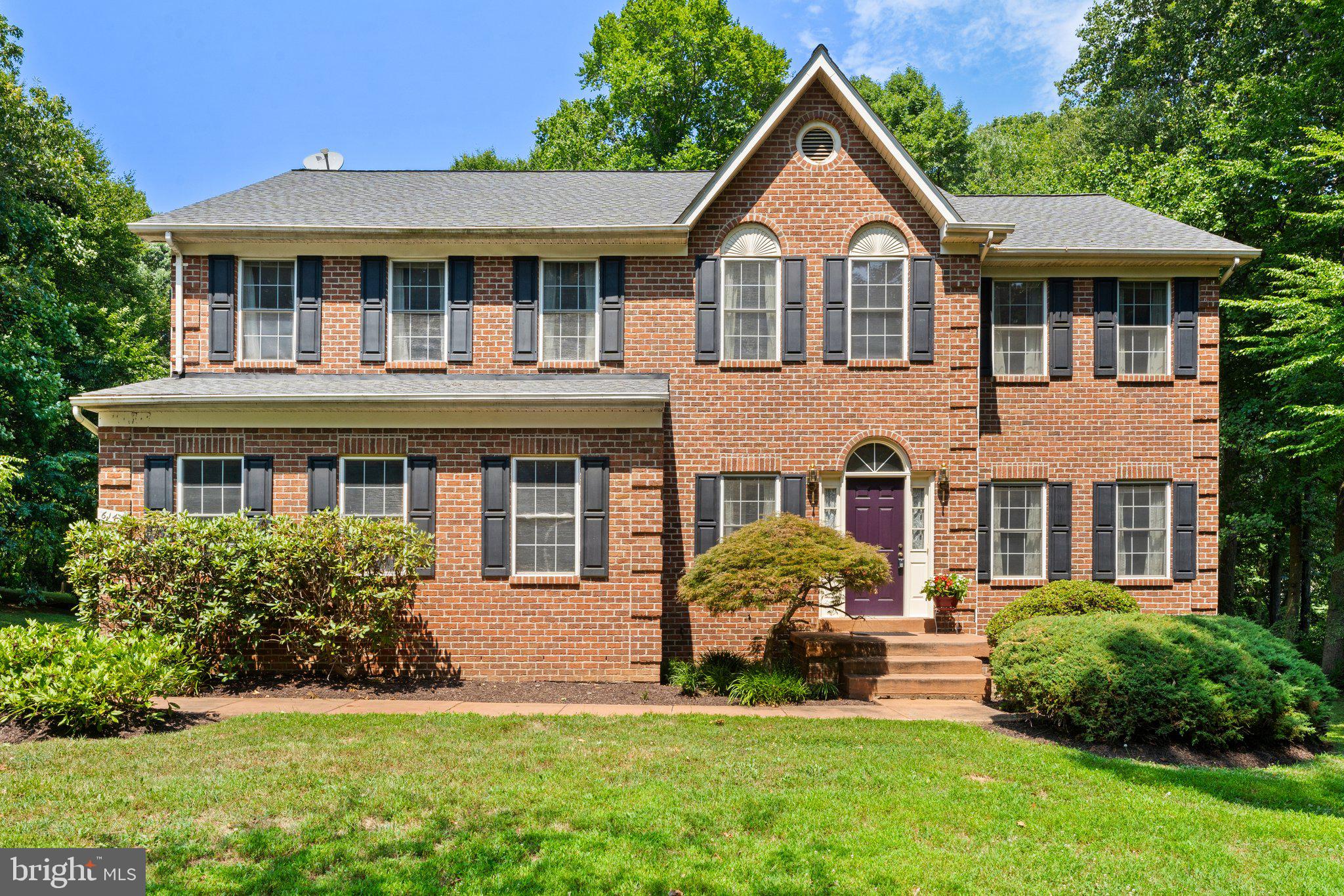 a front view of a house with a yard and porch