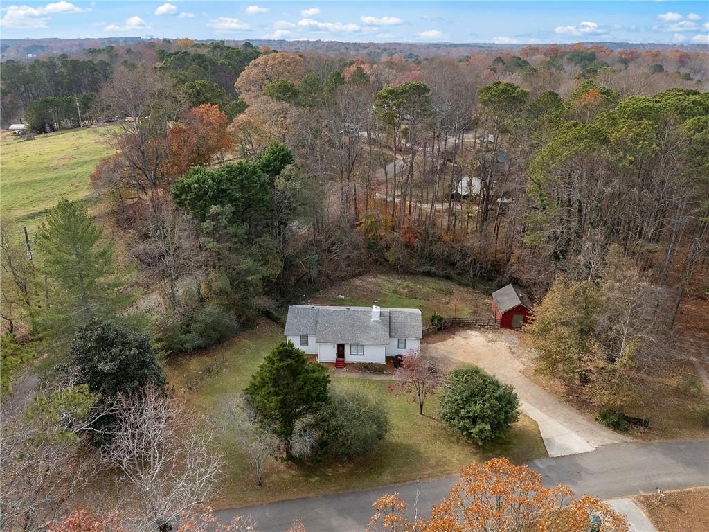 an aerial view of a house with a yard