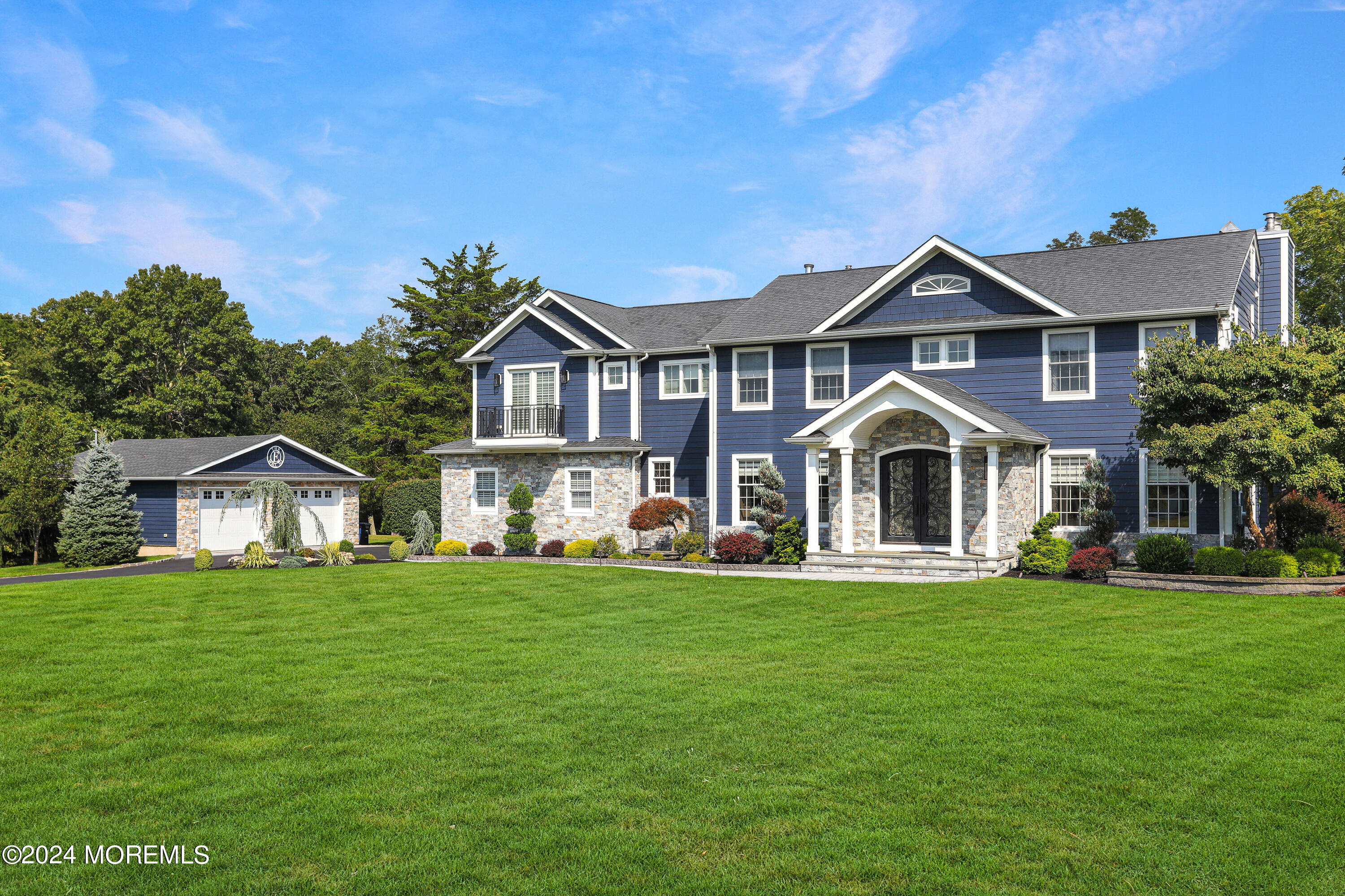 a front view of a house with a garden