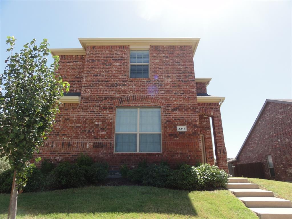 a brick building with a yard