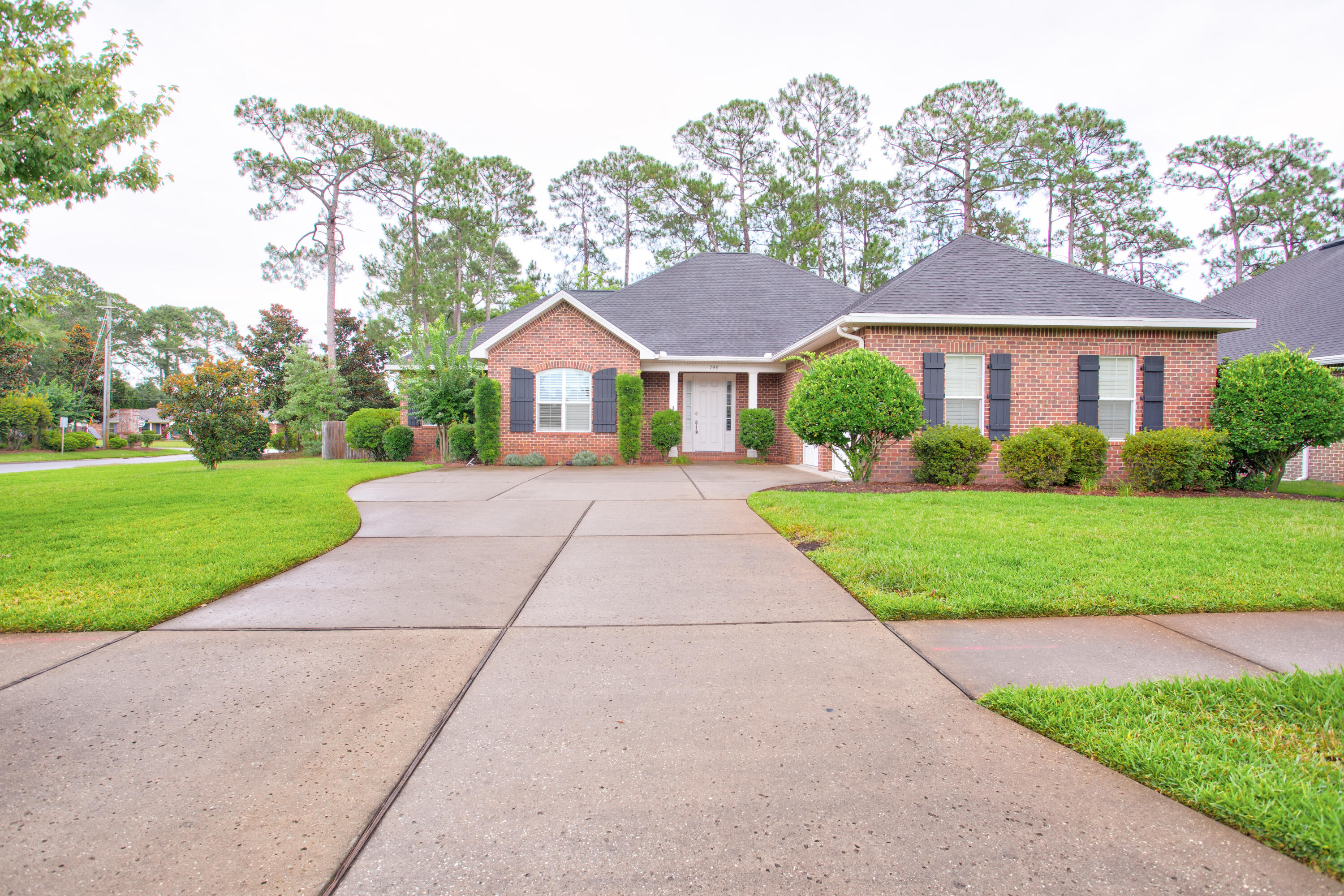 a front view of house with yard and green space