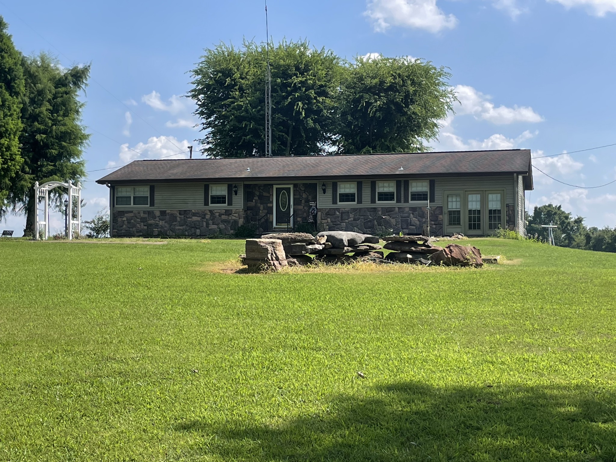 a front view of house with yard and outdoor seating