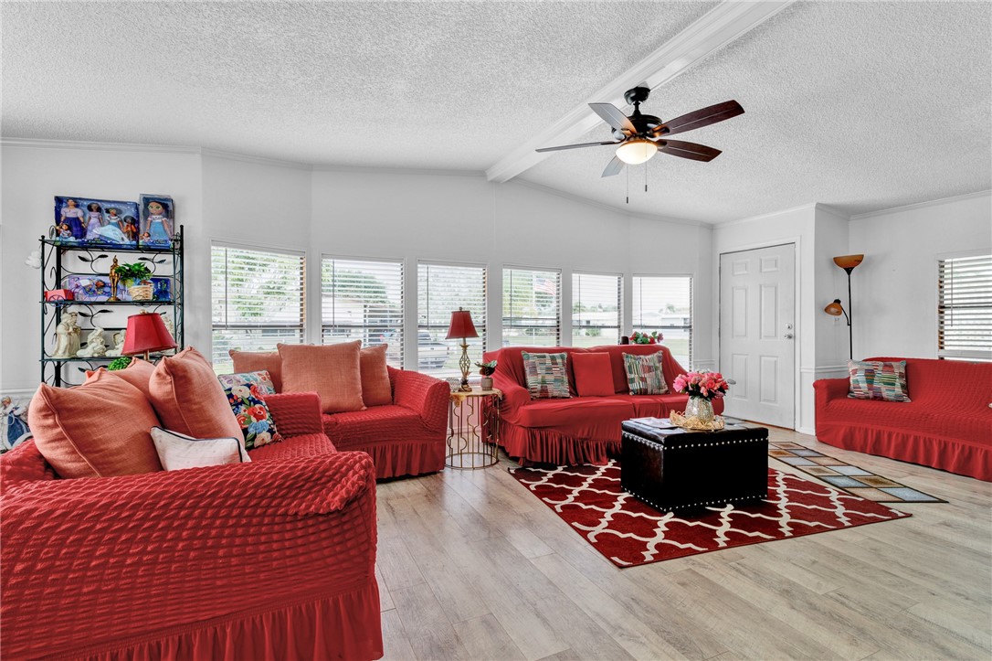 a living room with furniture a rug and a window